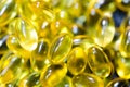 Fish oil pills closeup on black plate macro Royalty Free Stock Photo