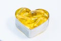 Fish Oil pills on heart isolated Royalty Free Stock Photo