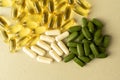 Fish oil pills and white capsules, green pills . translucent gelatin capsules, white non-transparent capsules, dark green chlorell