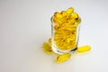 Fish oil and small glass of fish oil,clear background Royalty Free Stock Photo