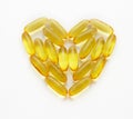 Fish oil supplements in a shape of a heart Royalty Free Stock Photo