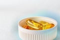 Fish oil. Yellow softgels or capsules are in white bottle cap. Light surface. Vitamins and healthy lifestyle. Bright background Royalty Free Stock Photo