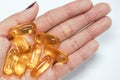 Fish oils capsule on human hand