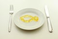 Fish from omega 3 capsules on a white plate