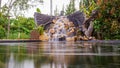 Fish pond with waterfall fountain. Garden waterfall landscaping with fishes, rocks, flowers and plants Royalty Free Stock Photo