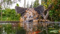 Fish pond with waterfall fountain. Garden waterfall landscaping with fishes, rocks, flowers and plants Royalty Free Stock Photo