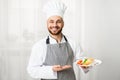 Chef Holding Plate With Roasted Salmon Steak Standing In Kitchen Royalty Free Stock Photo