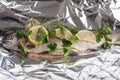 Fish river trout on a foil with spices ready for baking Royalty Free Stock Photo