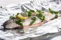 Fish river trout on a foil with spices ready for baking Royalty Free Stock Photo