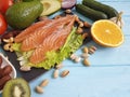 Fish salmon omega 3 avocado on blue wooden background healthy food Royalty Free Stock Photo