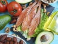 Fish salmon salad nourishment omega 3 avocado on blue wooden background healthy food