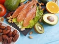 Fish salmon salad health nourishment omega 3 avocado on blue wooden background healthy food Royalty Free Stock Photo