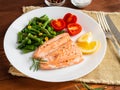 Fish salmon steamed with vegetables. Healthy diet food, dark woo Royalty Free Stock Photo