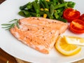 Fish salmon steamed with vegetables. Healthy diet food, dark woo Royalty Free Stock Photo