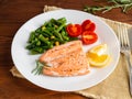 Fish salmon steamed with vegetables. Healthy diet food, dark woo Royalty Free Stock Photo