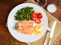 Fish salmon steamed with vegetables. Healthy diet food, dark woo Royalty Free Stock Photo