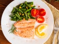 Fish salmon steamed with vegetables. Healthy diet food, dark woo Royalty Free Stock Photo