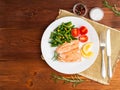 Fish salmon steamed with vegetables. Healthy diet food, dark woo Royalty Free Stock Photo