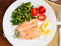 Fish salmon steamed with vegetables. Healthy diet food, dark woo Royalty Free Stock Photo