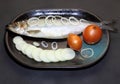 A fish. Salted marinated herring with onions on a platter.