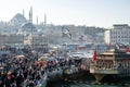 Fish sandwich shop boats in Eminonu Pier at to mouth of the Golden Horn Bay. Crowd of people outside in Eminonu Square, Istanbul, Royalty Free Stock Photo