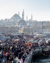 Fish sandwich shop boats in Eminonu Pier at to mouth of the Golden Horn Bay. Crowd of people outside in Eminonu Square, Istanbul, Royalty Free Stock Photo