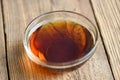 Fish sauce on glass bowl and wooden background, fish sauce obtained from fermentation fish or small aquatic animal, fermented Royalty Free Stock Photo