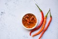 Fish sauce on white bowl and fresh chili on table, fish sauce obtained from fermentation fish or small aquatic animal, fermented