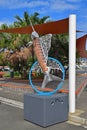 Fish Sculpture resembling swordfish outside of Noumea Wet Market with shade cover & green trees in the background