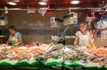 Fish seller in La Boqueria Market in Barcelona, Spain