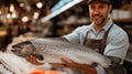 fish seller in hands with goods, market