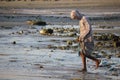 Fish seller out crossing the beach at sunset Royalty Free Stock Photo