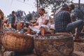 Fish seller selling fish and gall nut in a crowded fish market in Thalassery, kerala, india Royalty Free Stock Photo