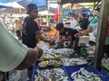fish seller serving customers in traditional market