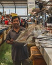 a fish seller showing his big fish the Brassy Trevally as trophy Royalty Free Stock Photo
