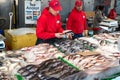 fish seller at a Washington seafood market uses a card reader to pay a customer