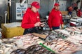 fish seller at a Washington seafood market uses a card reader to pay a customer