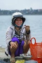 Fish selling woman with simple scale at market. Royalty Free Stock Photo