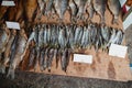 Rows of dried fish lie on counter