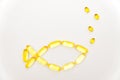 Fish shape Cod Liver Oil Capsules, Omega 3, Vitamin D on white background Royalty Free Stock Photo