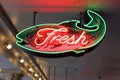 fish shop neon sign above the dining area in a restaurant