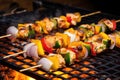 fish skewers cooked under an outdoor grill at picnic