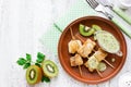 Fish skewers with fruit kiwi sauce on white table Royalty Free Stock Photo