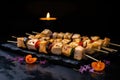 fish skewers under soft lighting on a black stone slab Royalty Free Stock Photo