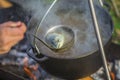 Fish soup boils in cauldron at the stake. Soup in a pot in the fire Royalty Free Stock Photo