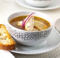 Fish soup in a bowl with fish, onion and bread Royalty Free Stock Photo