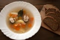 Fish soup from mackerel on white plate surved with bread.