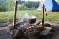 Fish soup preparation on a fire in a cauldron Royalty Free Stock Photo