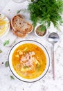 Fish soup with salmon, vegetables and rice in white bowl. Salmon soup.