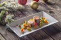 Fish starter food on white plate with christmas decoration. product photography and modern gastronomy